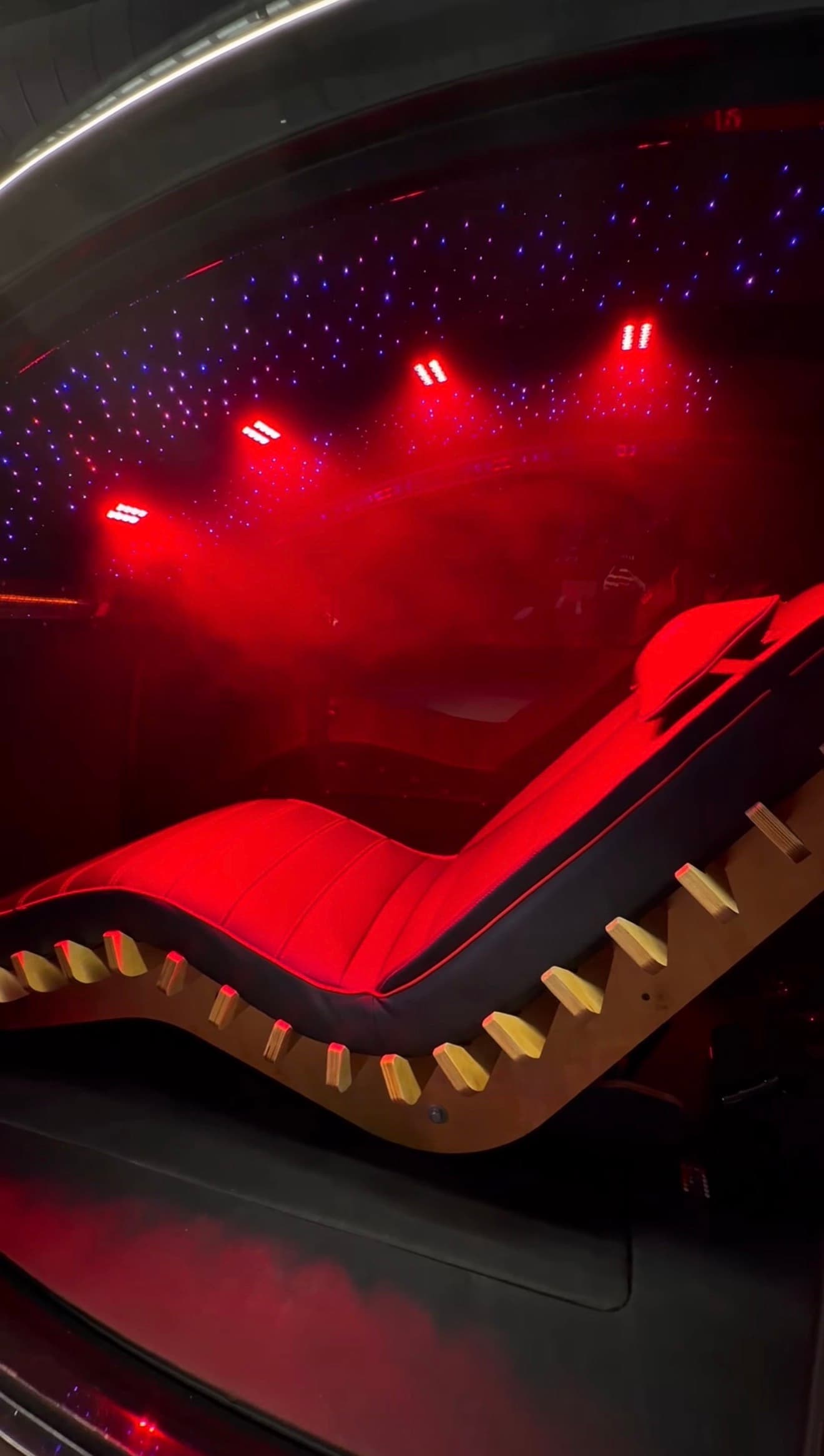 Red-lit reclining Longevity Capsule lounger under a starlit canopy at Eleve Longevity inside Aptare Labs