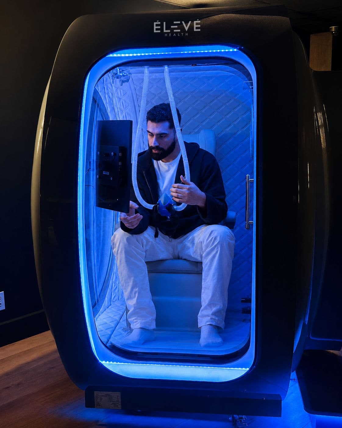 Man inside hyperbaric oxygen chamber at Eleve Newport Beach
